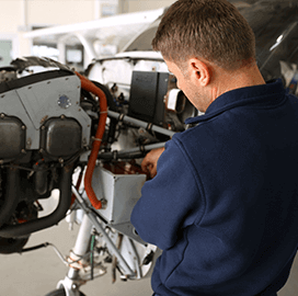 man fixing aircraft