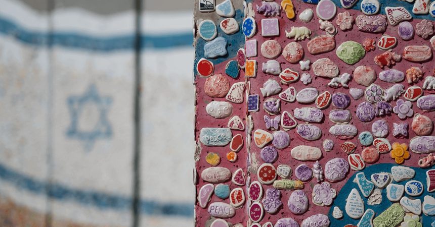 a wall of mosaic seashell with israel flag