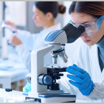 researcher using microscope